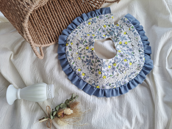 Frilly bib, blue strawberry pattern